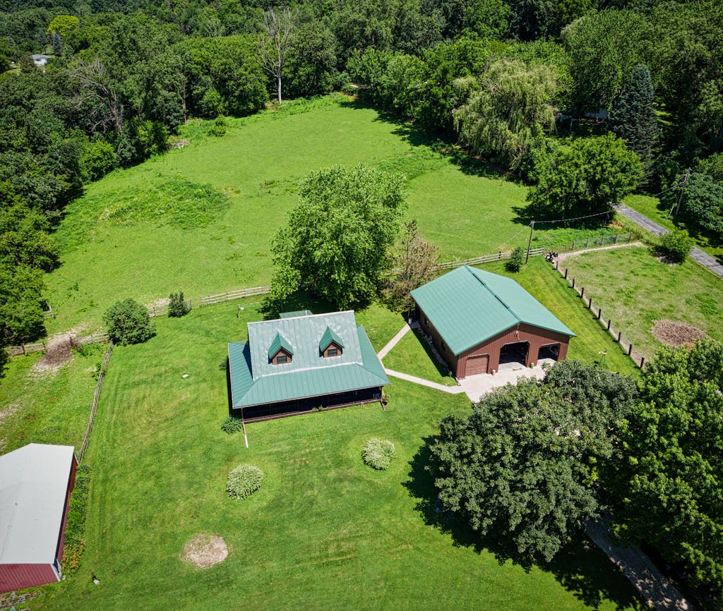 Aerial Photo of House Surrounded by Luscious Land